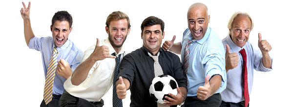 Team of happy businessmen cheering and embracing a soccer ball